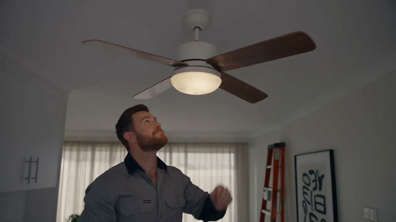 A ceiling fan running true, with Nathan looking up to check it from below